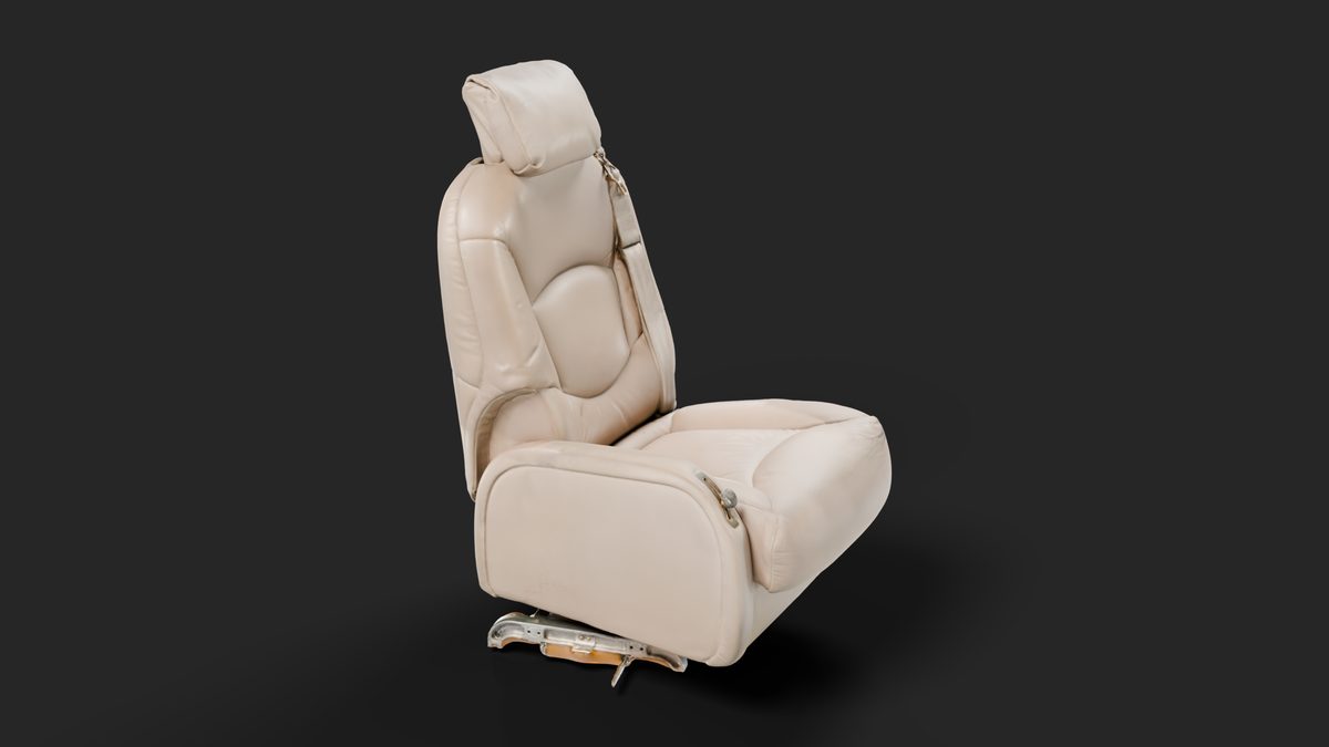 The seat from its other side and a little above, showing the creased leather and the seat track underneath